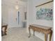 Bright entryway with hardwood floors, chandelier, and decorative wall art at 26837 Weiskopf Dr, Englewood, FL 34223