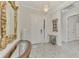 Elegant entryway featuring hardwood floors, chandelier, and ornate mirror at 26837 Weiskopf Dr, Englewood, FL 34223
