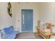 Elegant entryway features a teal door and charming decor at 26837 Weiskopf Dr, Englewood, FL 34223