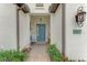 Inviting entryway with a teal door, decorative accents, and a cozy bench at 26837 Weiskopf Dr, Englewood, FL 34223