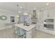 Modern kitchen with white cabinets, stainless steel appliances, and marble island at 26837 Weiskopf Dr, Englewood, FL 34223