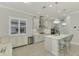 Modern kitchen with white cabinets, stainless steel appliances, and marble countertops at 26837 Weiskopf Dr, Englewood, FL 34223