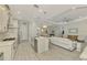 Open concept kitchen with stainless steel appliances and a large island at 26837 Weiskopf Dr, Englewood, FL 34223