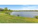 Serene lakefront view with lush green landscaping at 26837 Weiskopf Dr, Englewood, FL 34223