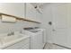 Bright laundry room with washer, dryer and extra cabinets at 26837 Weiskopf Dr, Englewood, FL 34223