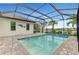Inviting pool area with covered patio, pavers, and tranquil water views at 26837 Weiskopf Dr, Englewood, FL 34223