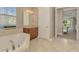 Spa-like bathroom with corner soaking tub and walk-in shower at 2744 Mill Creek Rd, Port Charlotte, FL 33953