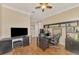 Home office with large desk, built-in shelving and TV at 2744 Mill Creek Rd, Port Charlotte, FL 33953