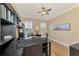 Home office with built-in bookshelves and hardwood floors at 2744 Mill Creek Rd, Port Charlotte, FL 33953