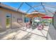 Large patio with covered lanai, comfortable seating, and pool access at 2744 Mill Creek Rd, Port Charlotte, FL 33953