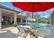 Stunning pool and patio with covered lanai, lounge chairs, and lush landscaping at 2744 Mill Creek Rd, Port Charlotte, FL 33953