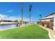 Landscaped backyard with artificial turf and waterfront views at 3015 Curry Ter, Port Charlotte, FL 33981