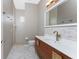 Modern bathroom with a wood vanity, updated fixtures, and tile flooring at 3015 Curry Ter, Port Charlotte, FL 33981