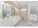 Double vanity bathroom with large mirror and glass block windows at 3015 Curry Ter, Port Charlotte, FL 33981