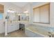 Elegant bathroom with soaking tub, double vanity, and tile flooring at 3015 Curry Ter, Port Charlotte, FL 33981