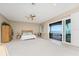 Bright bedroom featuring a king-size bed and access to a deck overlooking the water at 3015 Curry Ter, Port Charlotte, FL 33981