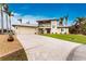 Two-story home with stone driveway and palm trees at 3015 Curry Ter, Port Charlotte, FL 33981