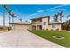 Two-story home with a metal roof, artificial turf, and a spacious driveway at 3015 Curry Ter, Port Charlotte, FL 33981