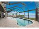 Relaxing pool and patio area with screened enclosure and water views at 3015 Curry Ter, Port Charlotte, FL 33981