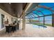 Covered patio with seating area overlooking the pool and waterfront at 3015 Curry Ter, Port Charlotte, FL 33981
