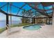 Relaxing pool area with covered patio, lounge chairs, and water view at 3015 Curry Ter, Port Charlotte, FL 33981