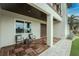 Covered porch with wood tile flooring and comfortable seating at 3015 Curry Ter, Port Charlotte, FL 33981