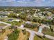 Scenic aerial view of a waterfront property with a canal, lush landscaping, and charming neighborhood at 3568 Middletown St, Port Charlotte, FL 33952