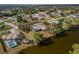 Aerial view of property situated on a waterfront with mature trees offering privacy and shade at 3568 Middletown St, Port Charlotte, FL 33952