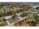An aerial view shows the home nestled in a quiet neighborhood with a nearby pond and tree-lined streets at 3568 Middletown St, Port Charlotte, FL 33952
