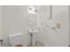 Neat half bathroom with a pedestal sink and classic fixtures, a convenient addition to the home at 3568 Middletown St, Port Charlotte, FL 33952