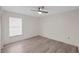 Bedroom with light gray wood-look flooring, ceiling fan and window at 3568 Middletown St, Port Charlotte, FL 33952