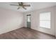 Bedroom with light gray wood-look flooring, ceiling fan and an exterior door at 3568 Middletown St, Port Charlotte, FL 33952