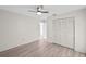Bedroom with light gray wood-look flooring, ceiling fan and closet at 3568 Middletown St, Port Charlotte, FL 33952