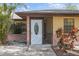 Charming entryway featuring a white front door with decorative glass and colorful foliage at 3568 Middletown St, Port Charlotte, FL 33952