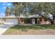 Charming home with a well-manicured lawn, attached garage, and inviting front entrance at 3568 Middletown St, Port Charlotte, FL 33952