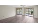 Bright living room with wood laminate flooring and screened patio access, perfect for entertaining at 3568 Middletown St, Port Charlotte, FL 33952