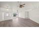 Spacious living room featuring hard surface flooring, a fan, and natural light from large windows at 3568 Middletown St, Port Charlotte, FL 33952