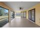 Spacious enclosed patio featuring screened windows, sliding glass doors and backyard view at 3568 Middletown St, Port Charlotte, FL 33952