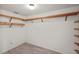 Spacious walk-in closet with custom wood shelving and light gray wood-look flooring at 3568 Middletown St, Port Charlotte, FL 33952