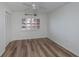 Bright bedroom with wood-look floors and ceiling fan at 365 Englewood Isles Pkwy # 3, Englewood, FL 34223