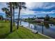 Scenic canal-front view with lush landscaping and boat docks at 365 Englewood Isles Pkwy # 3, Englewood, FL 34223