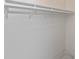 Empty closet with white walls and a hanging rod at 365 Englewood Isles Pkwy # 3, Englewood, FL 34223
