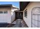 Home's entryway with a covered walkway and gate at 365 Englewood Isles Pkwy # 3, Englewood, FL 34223