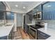 Updated kitchen featuring stainless steel appliances and blue cabinetry at 365 Englewood Isles Pkwy # 3, Englewood, FL 34223