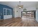 Bright living room with water views, built-in shelving, and wood-look floors at 365 Englewood Isles Pkwy # 3, Englewood, FL 34223