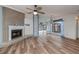 Living room featuring a brick fireplace and light wood flooring at 365 Englewood Isles Pkwy # 3, Englewood, FL 34223