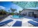 Community pool with lounge chairs and patio furniture at 365 Englewood Isles Pkwy # 3, Englewood, FL 34223