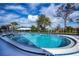 Inviting community pool with surrounding patio furniture at 365 Englewood Isles Pkwy # 3, Englewood, FL 34223