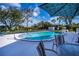 Community pool with lounge chairs and patio furniture at 365 Englewood Isles Pkwy # 3, Englewood, FL 34223