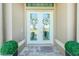 Front entrance with double doors and lush landscaping at 4 White Marsh Ln, Rotonda West, FL 33947